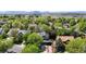 Aerial view of homes in a leafy neighborhood with mature trees, featuring manicured lawns at 2364 Autumn Ridge Blvd, Lafayette, CO 80026