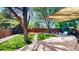 Spacious backyard featuring a lush green lawn, mature trees, seating area, and a wooden fence at 2364 Autumn Ridge Blvd, Lafayette, CO 80026
