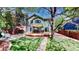 Beautiful backyard with lush lawn, mature trees, a large deck, and a shade sail creating a serene outdoor space at 2364 Autumn Ridge Blvd, Lafayette, CO 80026