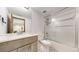 Bright bathroom featuring a vanity, toilet, and shower with glass doors and stylish black and white tile accents at 2364 Autumn Ridge Blvd, Lafayette, CO 80026