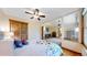 Bedroom with hardwood floors and ceiling fan featuring an adjacent suite area at 2364 Autumn Ridge Blvd, Lafayette, CO 80026