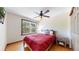 Cozy bedroom with hardwood floors, ceiling fan, and a large window that provides ample natural light at 2364 Autumn Ridge Blvd, Lafayette, CO 80026