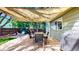 Relaxing backyard deck featuring a shade sail, dining table and chairs, as well as a grill at 2364 Autumn Ridge Blvd, Lafayette, CO 80026