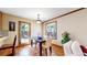Bright dining room with a dark wood table, saltillo tile floor, and a door to the outside patio at 2364 Autumn Ridge Blvd, Lafayette, CO 80026