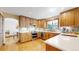 Bright kitchen with hardwood cabinets, white countertops, and stainless steel appliances at 2364 Autumn Ridge Blvd, Lafayette, CO 80026