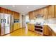 Spacious kitchen features stainless steel appliances, hardwood cabinets, and recessed lighting at 2364 Autumn Ridge Blvd, Lafayette, CO 80026