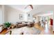 Open living area features hardwood floors, comfortable seating, and access to the dining room at 2364 Autumn Ridge Blvd, Lafayette, CO 80026