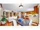 Open living space features a kitchen island, tile floors, stainless appliances, and a comfortable living room at 2364 Autumn Ridge Blvd, Lafayette, CO 80026