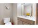 Well-lit powder room featuring a modern vanity, toilet, and neutral wall paint at 2364 Autumn Ridge Blvd, Lafayette, CO 80026