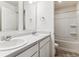 Well-lit bathroom featuring dual sinks and tub at 27460 E Cedar Pl, Aurora, CO 80018