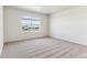 Well-lit bedroom with a large window and neutral carpeting at 27460 E Cedar Pl, Aurora, CO 80018