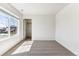 A bedroom features neutral carpet, large window with neighborhood view, and a walk-in closet at 27460 E Cedar Pl, Aurora, CO 80018