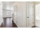 Hallway with hardwood floors, white trim, and doorways to other rooms in the house at 27460 E Cedar Pl, Aurora, CO 80018