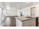 Bright, open-concept kitchen with a granite countertop island and stainless steel appliances at 27460 E Cedar Pl, Aurora, CO 80018