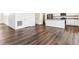 Open-concept living space with hardwood floors, white trim, and seamless transition to kitchen at 27460 E Cedar Pl, Aurora, CO 80018