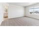 Large main bedroom showcasing a window and en-suite bathroom entrance at 27460 E Cedar Pl, Aurora, CO 80018
