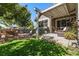 Beautifully landscaped backyard with covered patio, lush lawn, and outdoor seating area at 5419 Uinta St, Denver, CO 80238