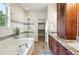 Luxurious bathroom features a soaking tub, glass shower, and granite countertop vanity at 5419 Uinta St, Denver, CO 80238