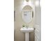 Powder bathroom featuring an oval mirror, neutral walls, and pedestal sink at 5419 Uinta St, Denver, CO 80238