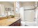 Bathroom featuring a shower and tub combination with decorative tiling, and granite counters at 5419 Uinta St, Denver, CO 80238