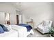 Light-filled bedroom with vaulted ceilings, chair, and a glimpse into the ensuite at 5419 Uinta St, Denver, CO 80238