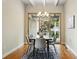 Bright dining room features wood floors, modern lighting, and sliding glass door to backyard at 5419 Uinta St, Denver, CO 80238