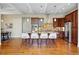 Beautiful kitchen with a large island featuring seating, stainless steel appliances, and hardwood floors at 5419 Uinta St, Denver, CO 80238