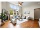 Bright living room with hardwood floors, a fireplace, and a large window offering a view of the yard at 5419 Uinta St, Denver, CO 80238