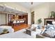 Open concept living space featuring wood floors, large kitchen, fireplace, and ample seating at 5419 Uinta St, Denver, CO 80238