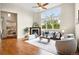 Inviting living room with fireplace, sofa, hardwood floors, and a bright window to the backyard at 5419 Uinta St, Denver, CO 80238
