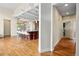 Open floor plan into kitchen area, with an eat-in island and hardwood floors at 5419 Uinta St, Denver, CO 80238