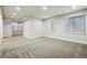 Bright living room with large windows, neutral paint, and plush carpeting at 5419 Uinta St, Denver, CO 80238