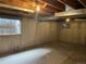 Unfinished basement with concrete walls, exposed ceiling, and small window at 10008 Quivas St, Thornton, CO 80260