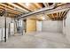 Unfinished basement space with exposed beams, mechanicals, and potential for customization at 10008 Quivas St, Thornton, CO 80260