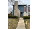 Charming two-story home with unique stone chimney, blue siding, and manicured lawn at 10008 Quivas St, Thornton, CO 80260