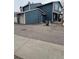 An exterior view of the home and its attached two-car garage and large parking pad at 10008 Quivas St, Thornton, CO 80260