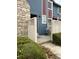 Exterior of charming townhouse with stone chimney, a cozy fenced-in patio area, and a welcoming entrance at 10008 Quivas St, Thornton, CO 80260