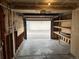 Spacious garage with an open door with shelving, and partially insulated walls at 10008 Quivas St, Thornton, CO 80260