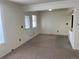 Bright living room with neutral carpet, ample natural light, and an open floor plan at 10008 Quivas St, Thornton, CO 80260