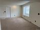 Bright living room featuring a window bench and neutral carpet at 10008 Quivas St, Thornton, CO 80260