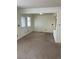 Open-concept living room featuring carpet, and breakfast bar at 10008 Quivas St, Thornton, CO 80260