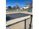 Community pool covered for the off-season, surrounded by tennis courts at 10008 Quivas St, Thornton, CO 80260