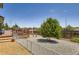 Spacious backyard featuring a deck, a gravel area, and a large tree, perfect for outdoor gatherings and relaxation at 3762 S Halifax St, Aurora, CO 80013