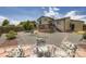 Outdoor space featuring a patio with a glass table and rock landscaping with a home and deck in the background at 3762 S Halifax St, Aurora, CO 80013
