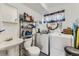 Functional bathroom and laundry area with a sink, toilet, washer and dryer, maximizing space with practical storage solutions at 3762 S Halifax St, Aurora, CO 80013