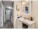 Clean and functional bathroom with a white vanity, an illuminated mirror, and neutral decor at 3762 S Halifax St, Aurora, CO 80013