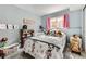 Charming bedroom with playful decor, a window with pink curtains, and a cozy bed at 3762 S Halifax St, Aurora, CO 80013