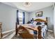 Comfortable bedroom with a classic wooden bed frame and a large window allowing natural light at 3762 S Halifax St, Aurora, CO 80013