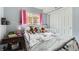 Cozy bedroom featuring a twin bed with minnie mouse sheets and plush toys, accented by pink curtains and side table decor at 3762 S Halifax St, Aurora, CO 80013