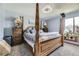 Spacious bedroom with a distinctive canopy bed, a ceiling fan, and bright natural lighting at 3762 S Halifax St, Aurora, CO 80013